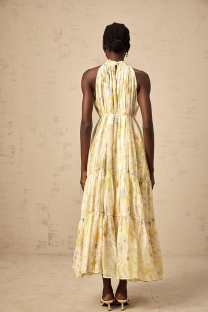 Sleeveless yellow midi dress with floral print pattern called Ulani