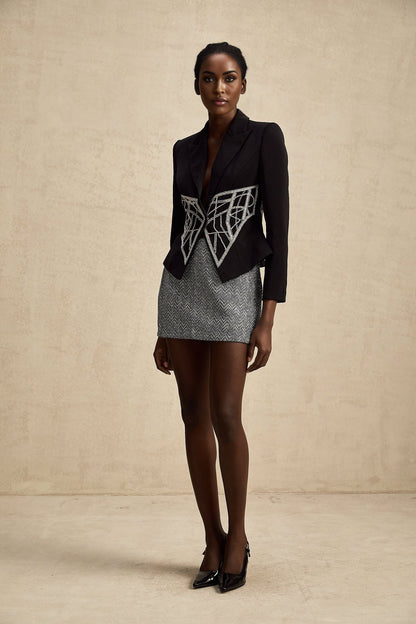 Black fitted jacket with cinched waist and embellished details