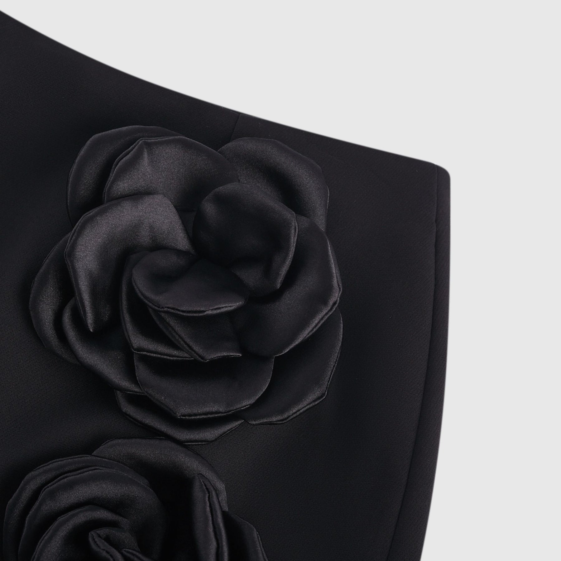 Black mini skirt with artificial flowers by Nalini