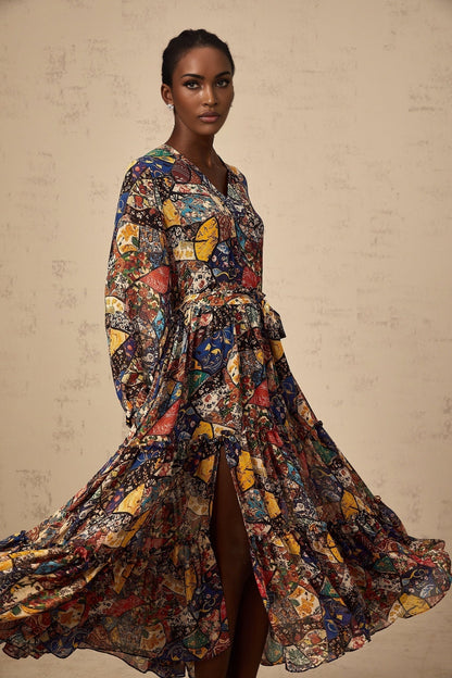 A woman wearing a brown bohemian style midi dress with shirring details and a flowy silhouette