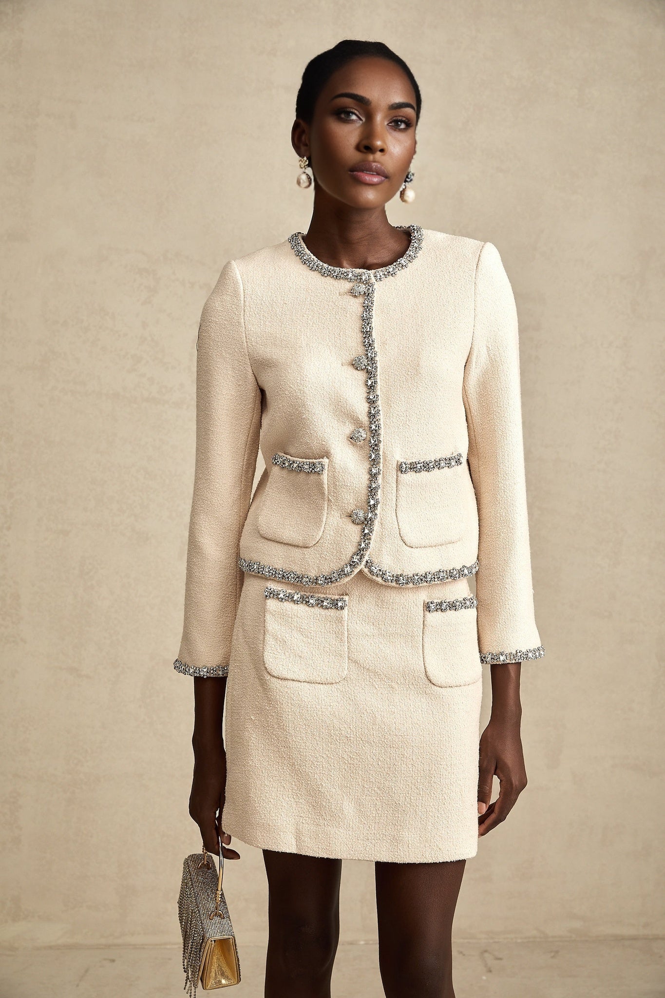 A beige tweed cardigan and matching skirt set with crystal embellishments named Elisabeth featuring a classic and elegant design