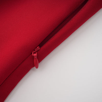 Woman wearing long red pleated maxi dress with high slit for Valentines Day