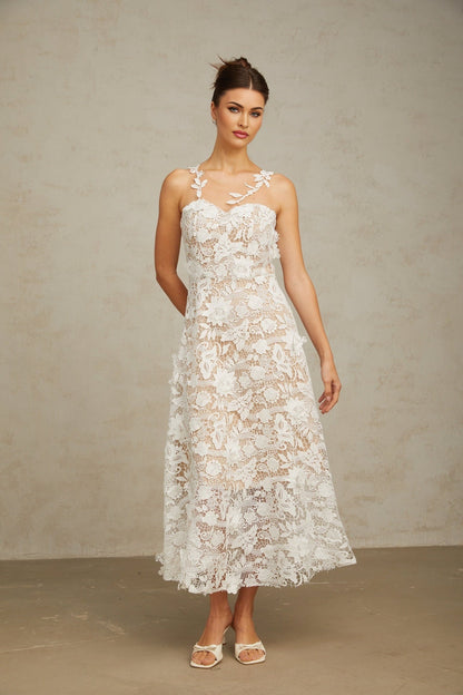 A white midi dress with lace detailing and tulle panels featuring a delicate and feminine design