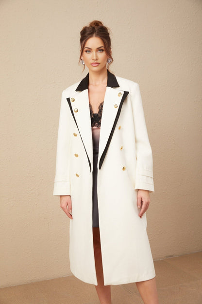 A long doublebreasted blazer featuring color blocks in different shades of wool fabric with a terracotta or earth tone color scheme