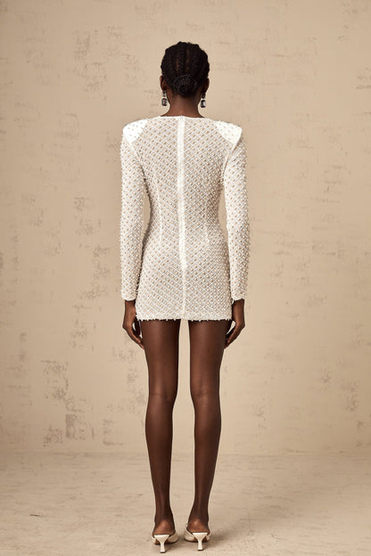 A white mini dress with cutout details and a decorative bowknot embellishment
