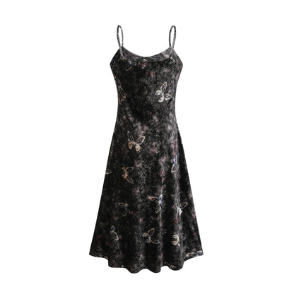 A black velvet midi dress with a butterfly print pattern featuring a fitted bodice and flared skirt