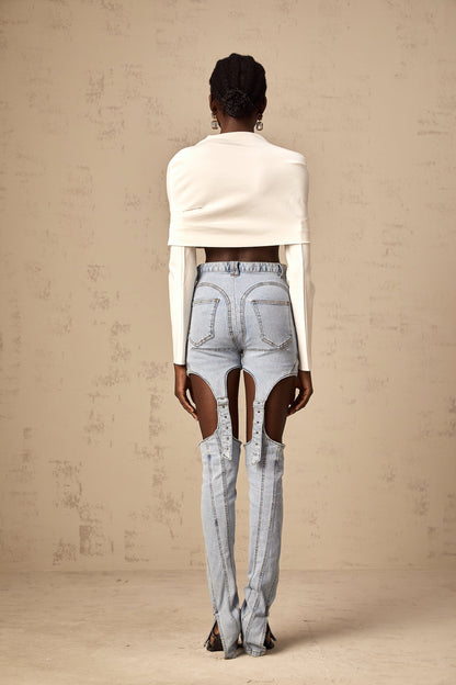 Young woman wearing a white cropped top with ruched detailing and short sleeves