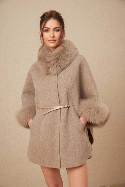 Woman wearing brown wool cape coat with fur trim and belt cinched at waist