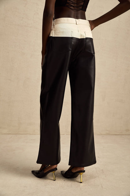 Black leather trousers with contrasting white side panels and waistband