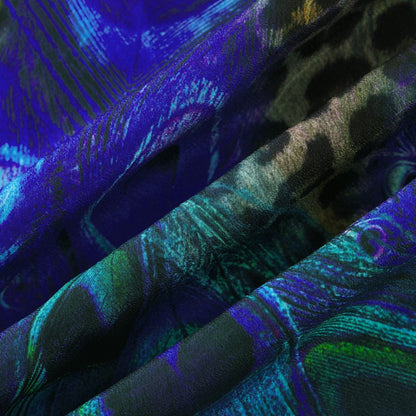 Woman wearing a silky blue sleeveless jumpsuit with halter neckline and flowing wide leg pants