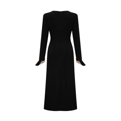 A long maxi dress with a vneck and contrasting colors featuring a bow detail at the neckline