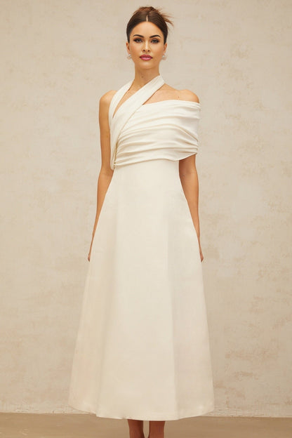 A long creamwhite maxi dress with an asymmetric design featuring a Solene label