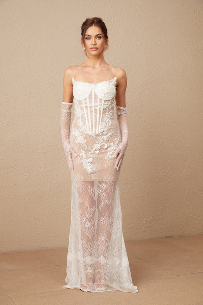 A long white tulle maxi dress with a corset bodice featuring colorful floral embroidery and delicate straps