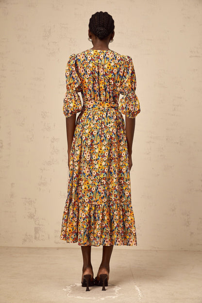 A yellow midi dress with a floral print pattern and Vneck design named Éliane