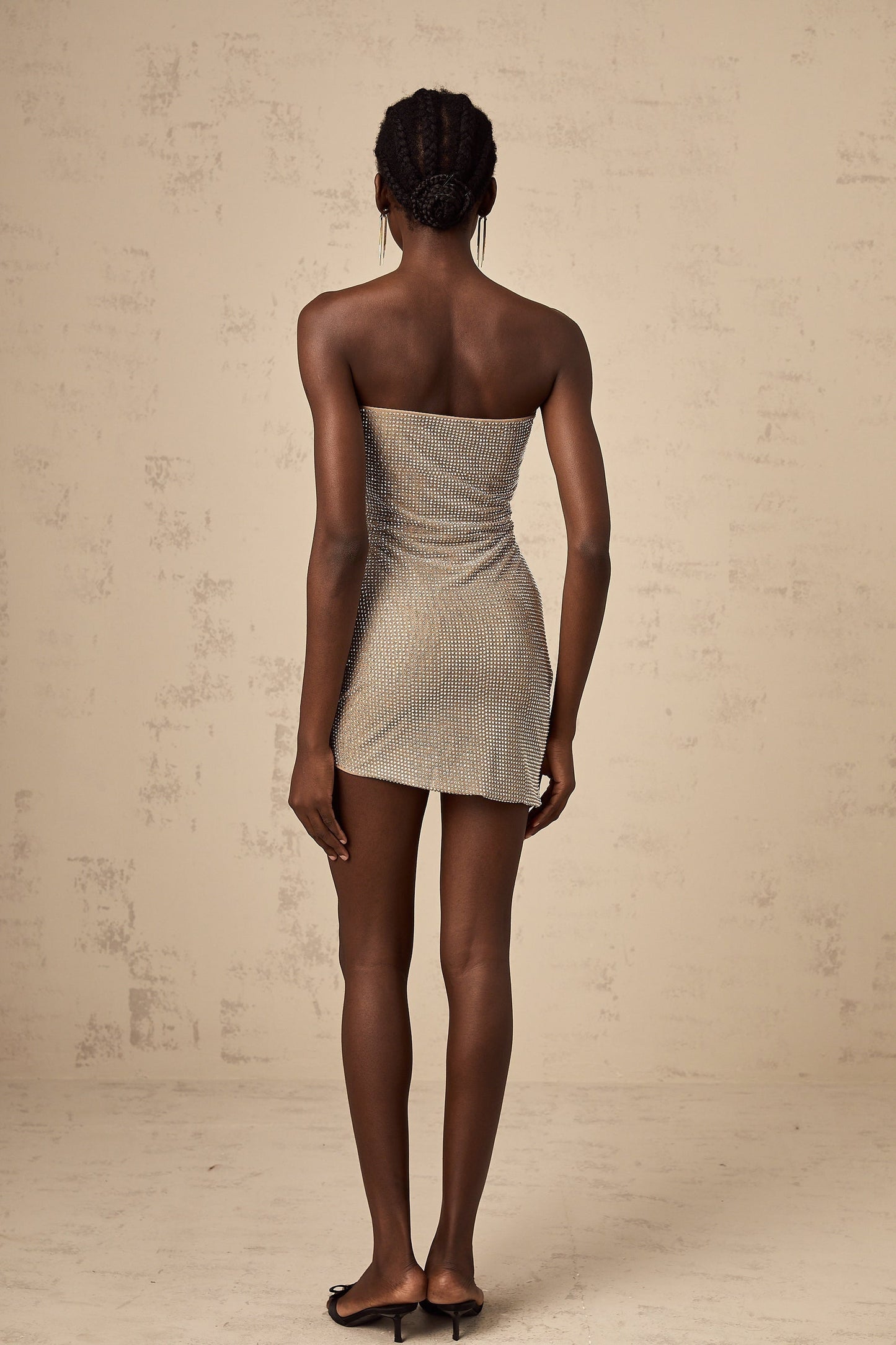 A short glittering mini dress with rhinestone embellishments and strategic cut out details named Penelope