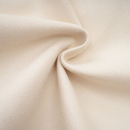 Woman wearing white suede short coat with fur trim and padded design