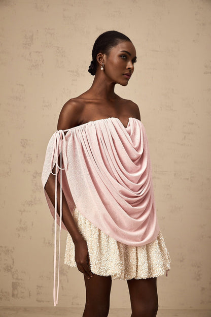A pink offshoulder top with ruched detailing called Quintina worn by a model against a plain background