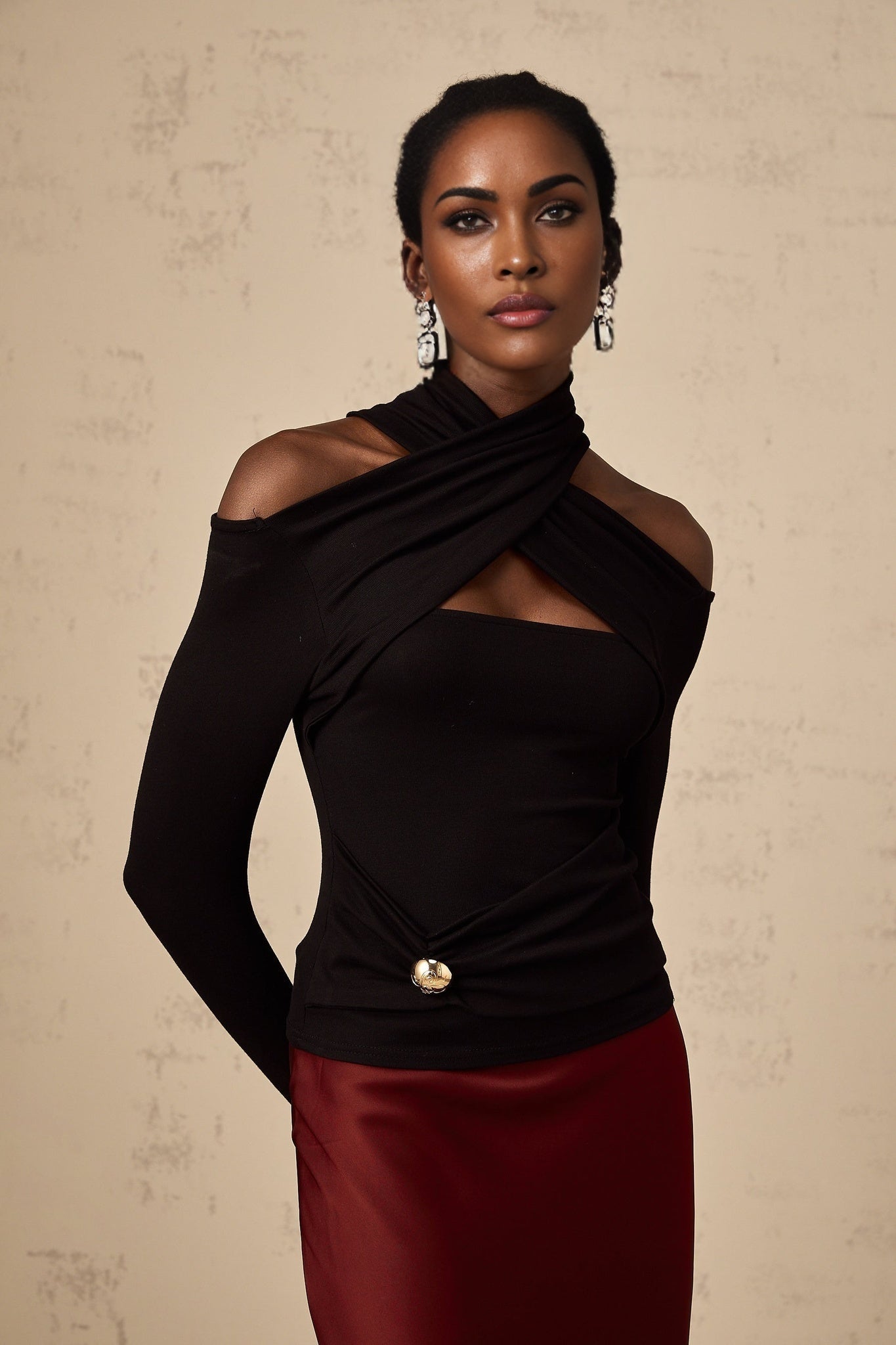 A black stretchy top with ruched detailing named Odette