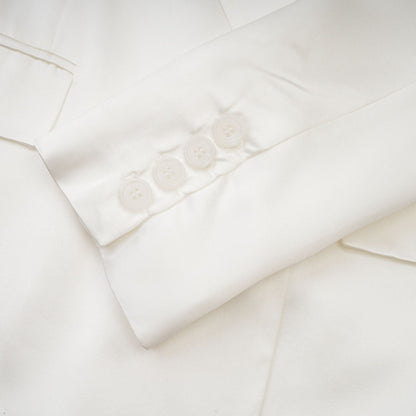 A white doublebreasted blazer named Sylvie worn by a model against a plain background