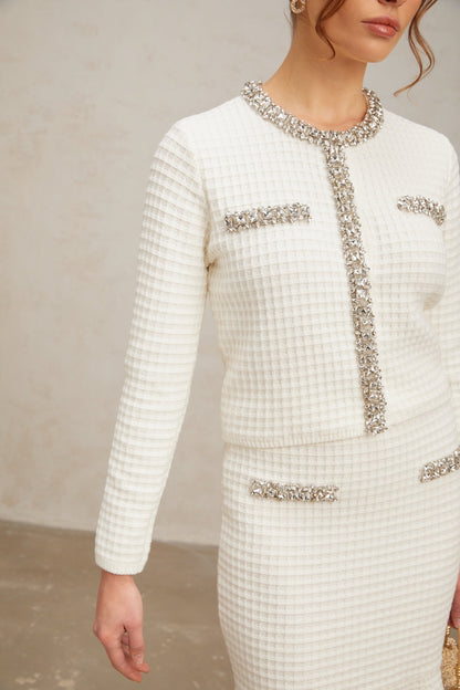 Woman wearing white waffle knit cardigan and matching skirt set with embellished details Frida style