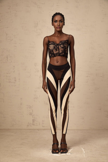 A pair of womens leggings featuring a spiral color block design with multiple colored panels in a swirling pattern