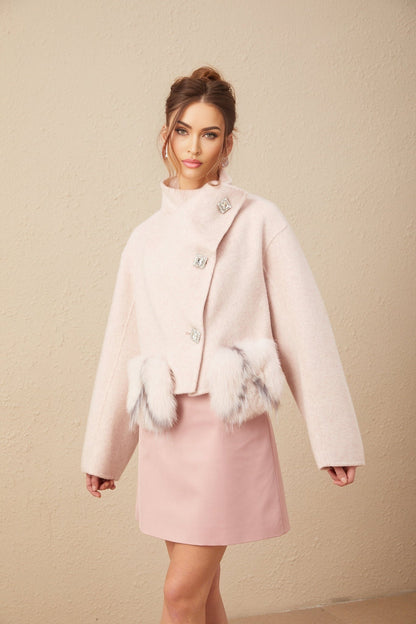 A pink short coat with a diagonal placket closure featuring a modern design and tailored fit suitable for formal or casual wear