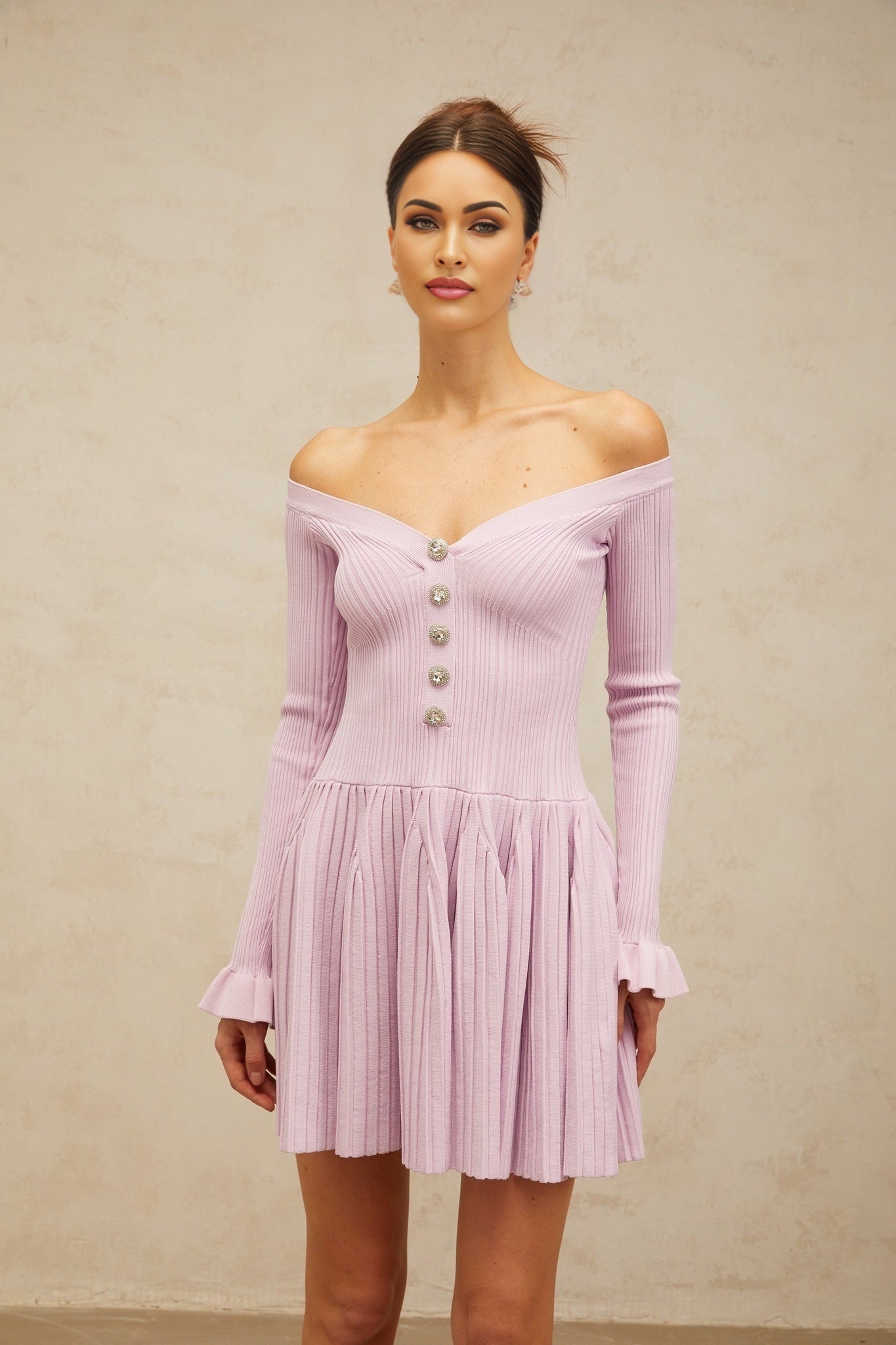 A light purple mini dress with an offshoulder neckline and ribbed knit texture worn by a model
