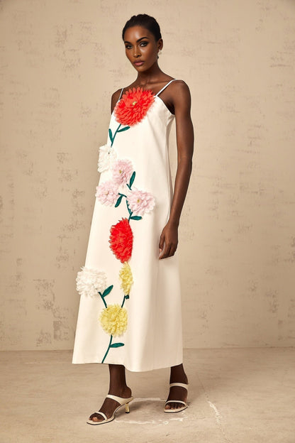 White sleeveless midi dress with three dimensional petal details on the bodice
