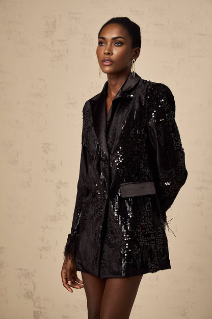 A black blazer with sequin embellishments and feather trim details along the edges named Ariane