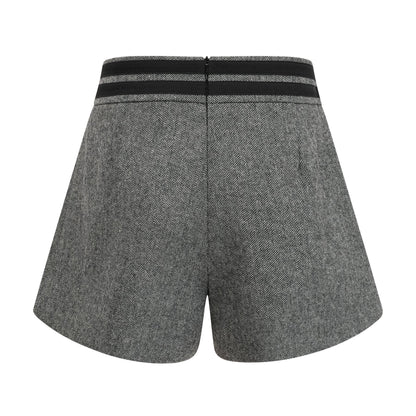 Woman wearing grey herringbone pattern matching top and shorts set