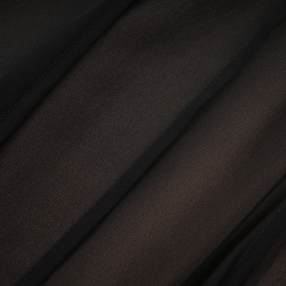 Woman wearing long flowy maxi skirt with ruffles and pleats in soft tulle fabric