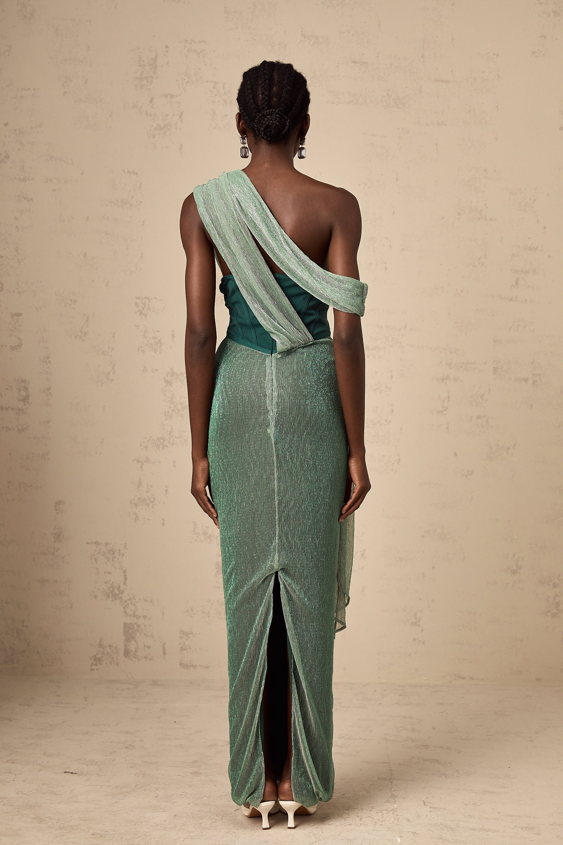 A green maxi dress with a corset bodice featuring a ribbon design and a long flowing skirt