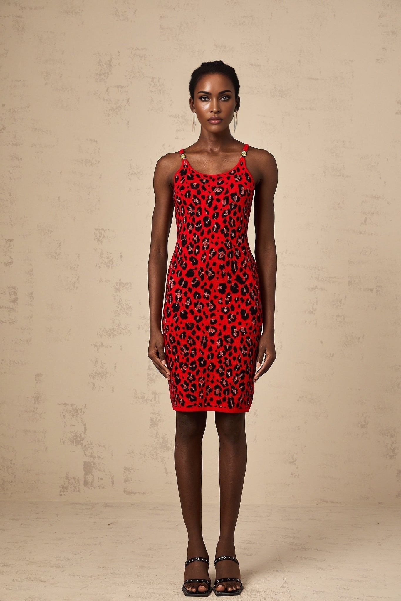A red mini dress with a leopard print pattern made from shimmering lurex fabric featuring a short hemline and likely a fitted silhouette