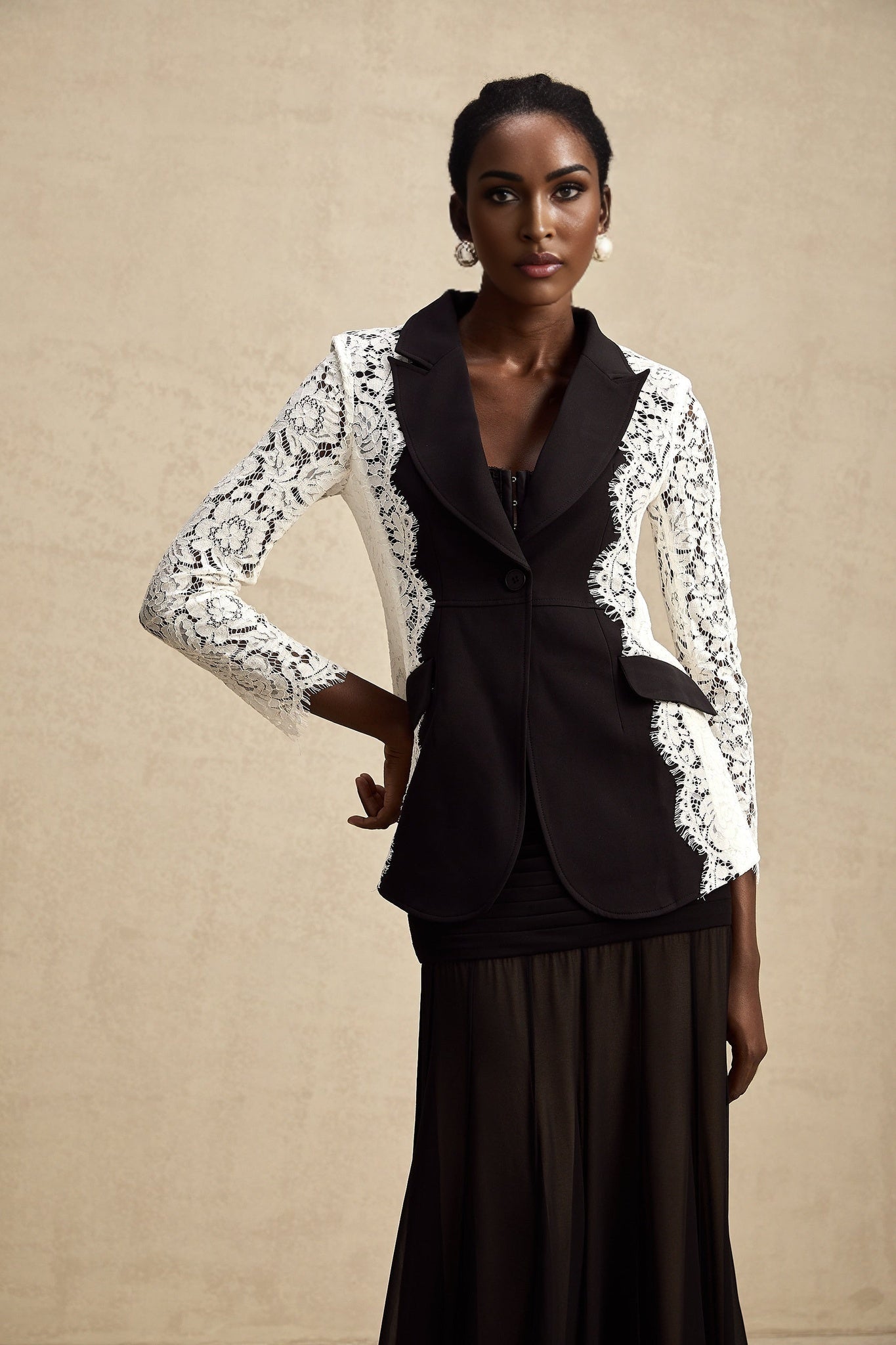 A stylish womens blazer featuring color block design and lace trim details named Sandrine