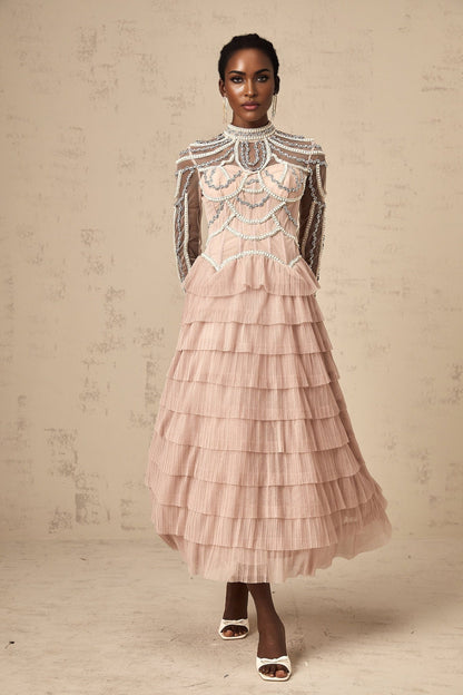 A pink gown with beaded details and tiered semisheer layers