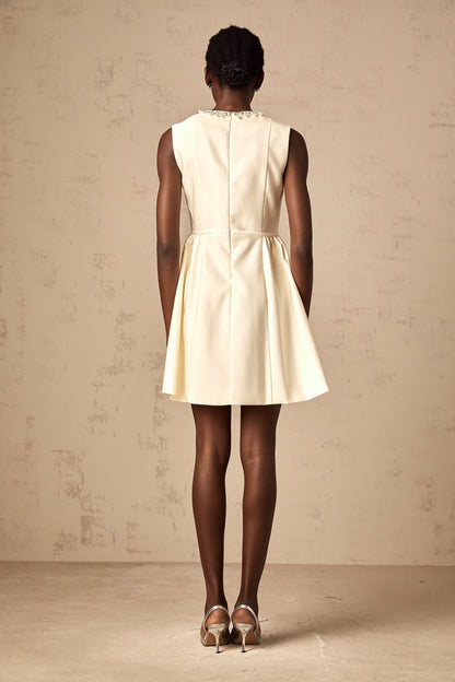 A short white mini dress with a bowknot embellishment named Isabelle