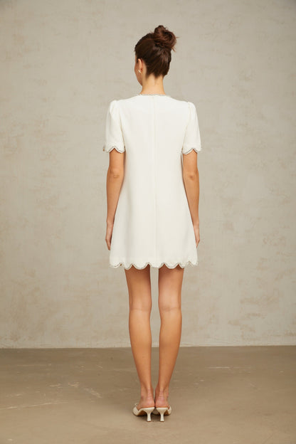 A short white mini dress adorned with crystal embellishments named Berenice