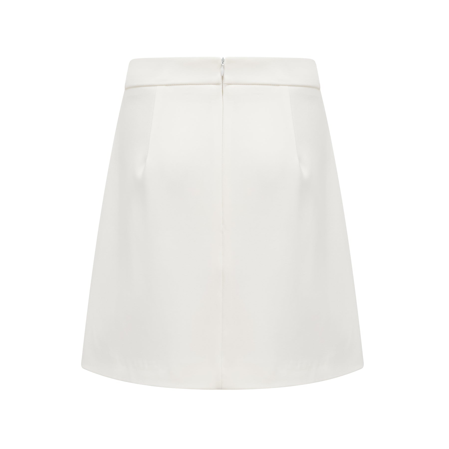 Woman wearing white twopiece outfit with crystal embellishments consisting of a sleeveless top and matching skirt