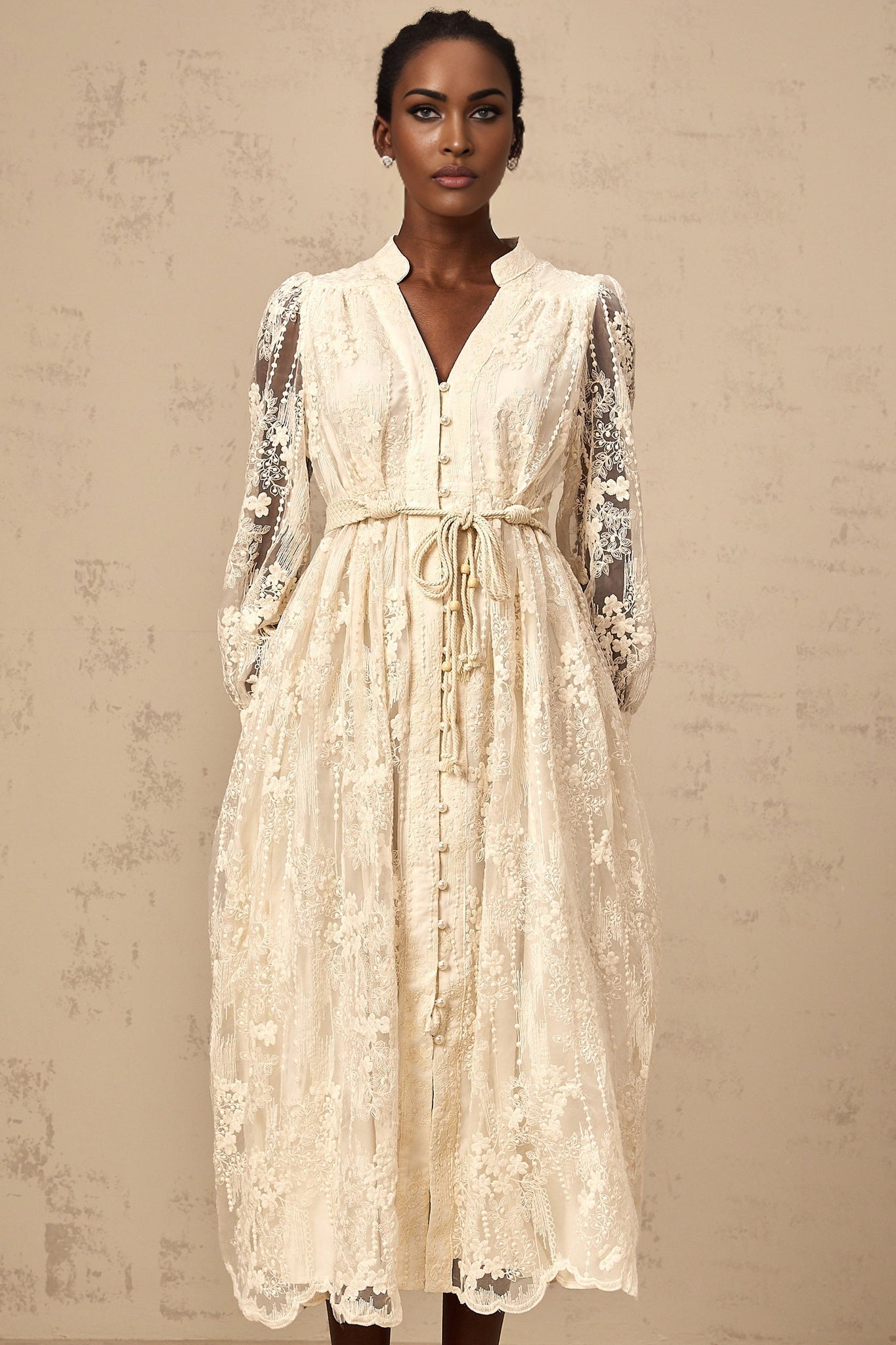 Woman wearing neutral colored midi dress with lace embroidery details