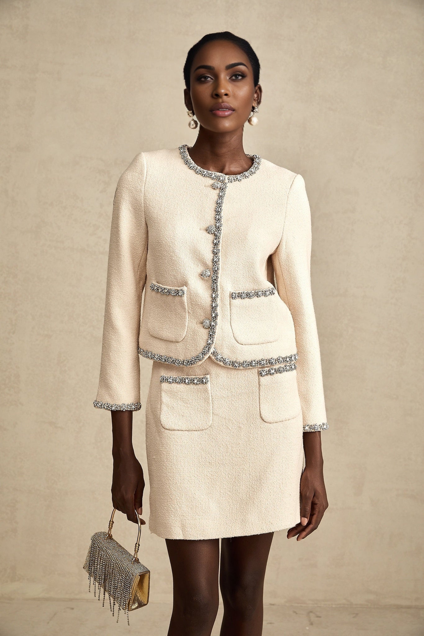Woman wearing beige tweed cardigan and matching skirt set with crystal embellishments named Elisabeth