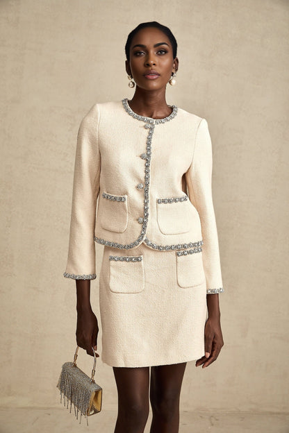 Woman wearing beige tweed cardigan and matching skirt set with crystal embellishments named Elisabeth