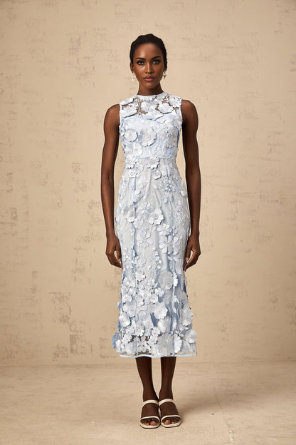 A blue midi dress with floral applique details featuring the Herta design