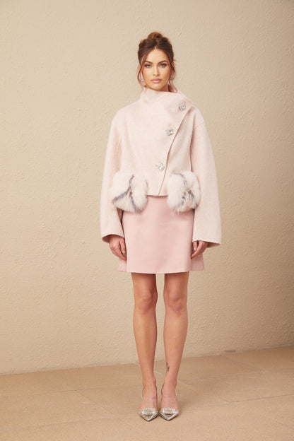 A pink short coat with a diagonal placket closure featuring a stylish design called Vienne