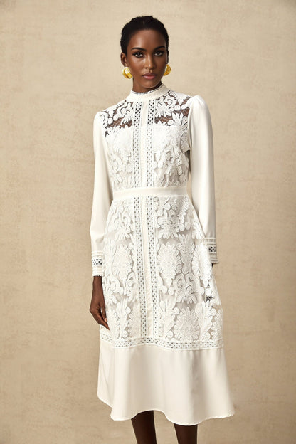 A white midi dress with panelled design and embroidery details named Madeleine featuring a fitted silhouette and delicate floral patterns