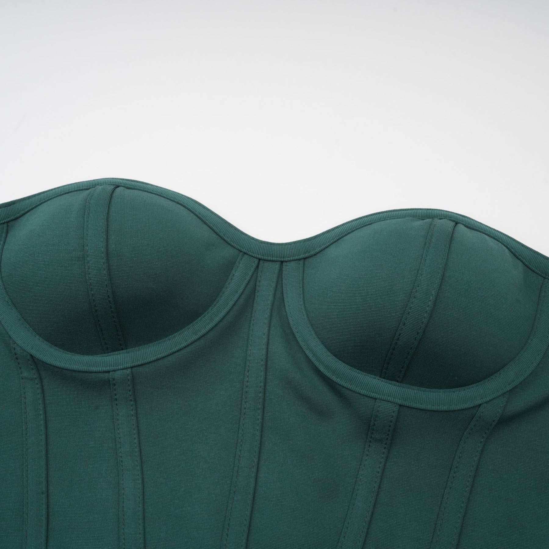 A green maxi dress featuring a corset bodice with ribbon detailing and a long flowing skirt