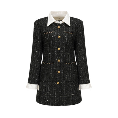 Woman wearing a black mini dress with sequin panels and tweed fabric featuring a sleeveless design and round neckline