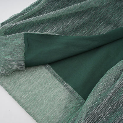 A green maxi dress with a corset bodice featuring a ribbon design and a long flowing skirt