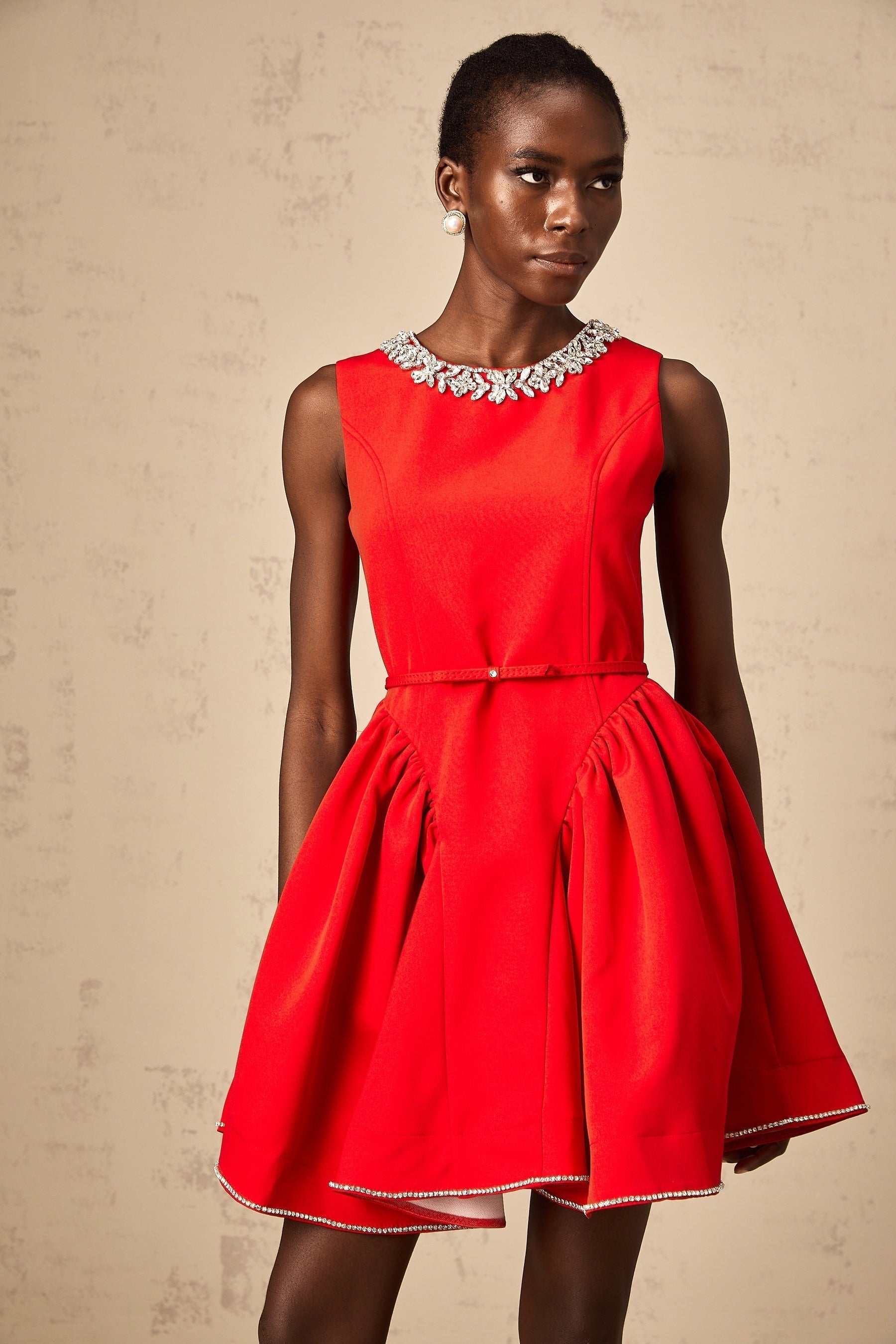 A red mini dress with pleats and embellishments named Leonie