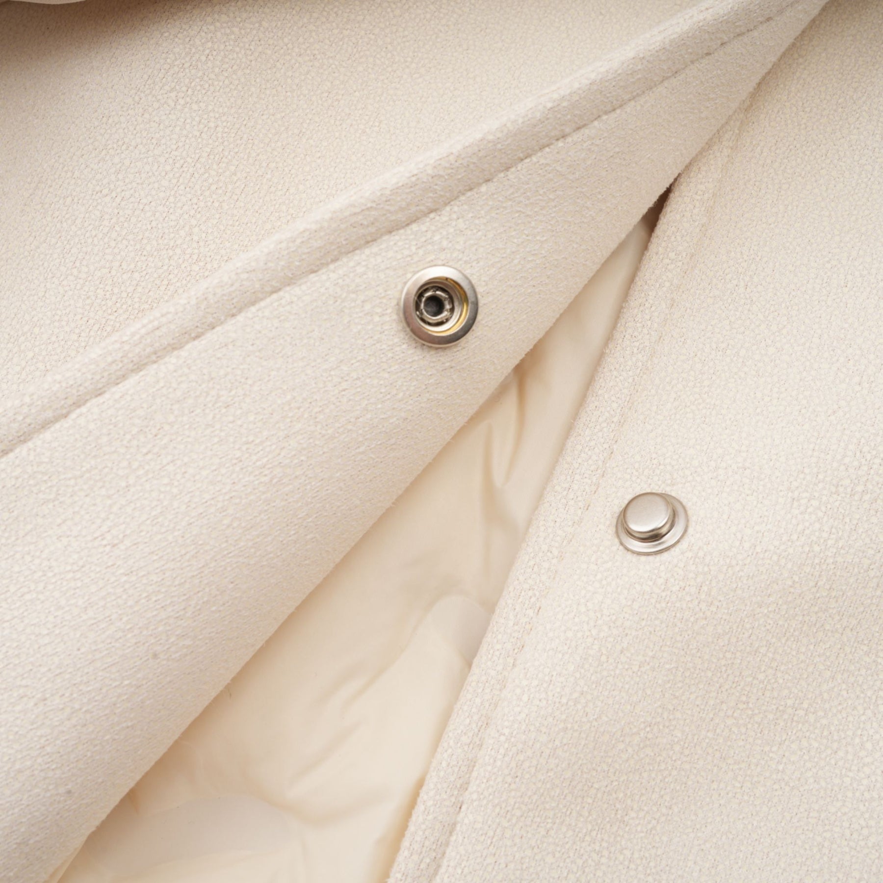 Woman wearing white suede short coat with fur trim and padded design