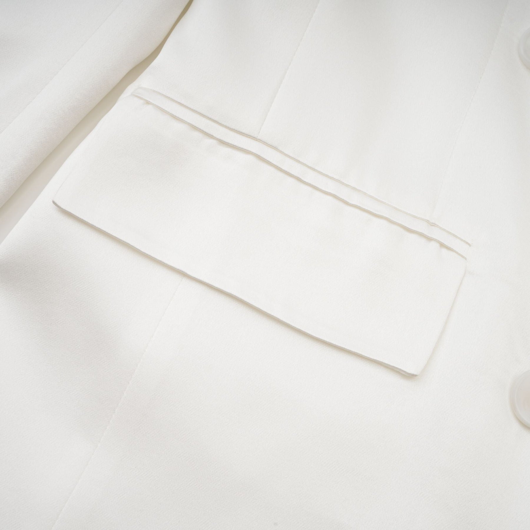 A white doublebreasted blazer named Sylvie on a plain background